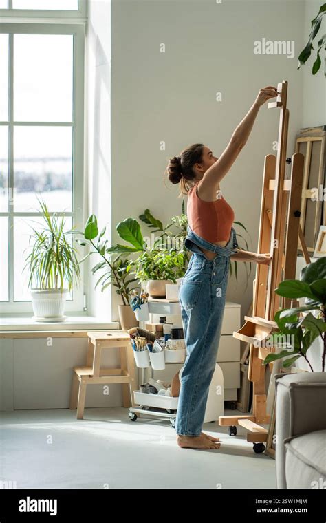 Woman painting in a sunny studio
